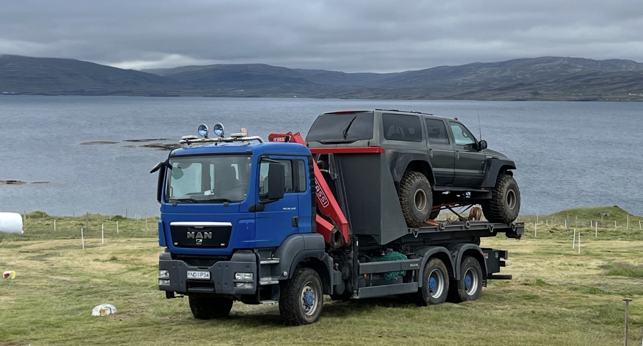MAN transport truck carrying a modified off-road vehicle